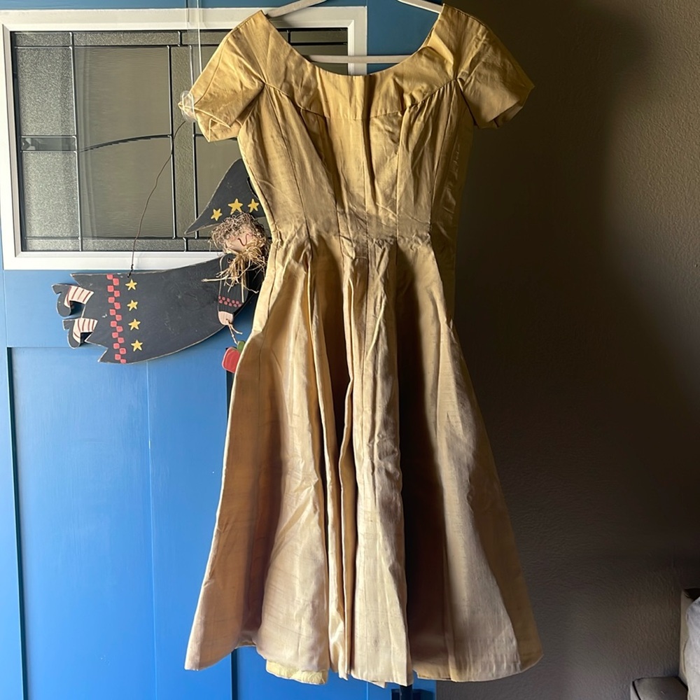 This is the cutest little dress in gold